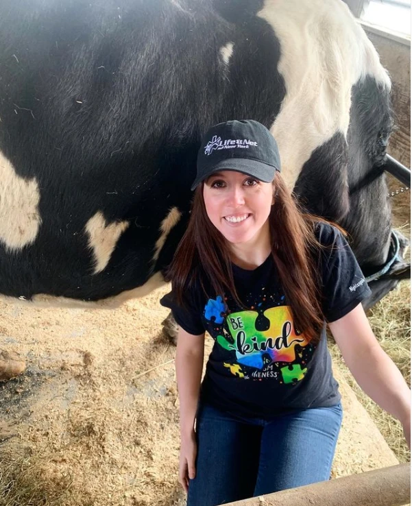 Marissa with a Holstein in the barn