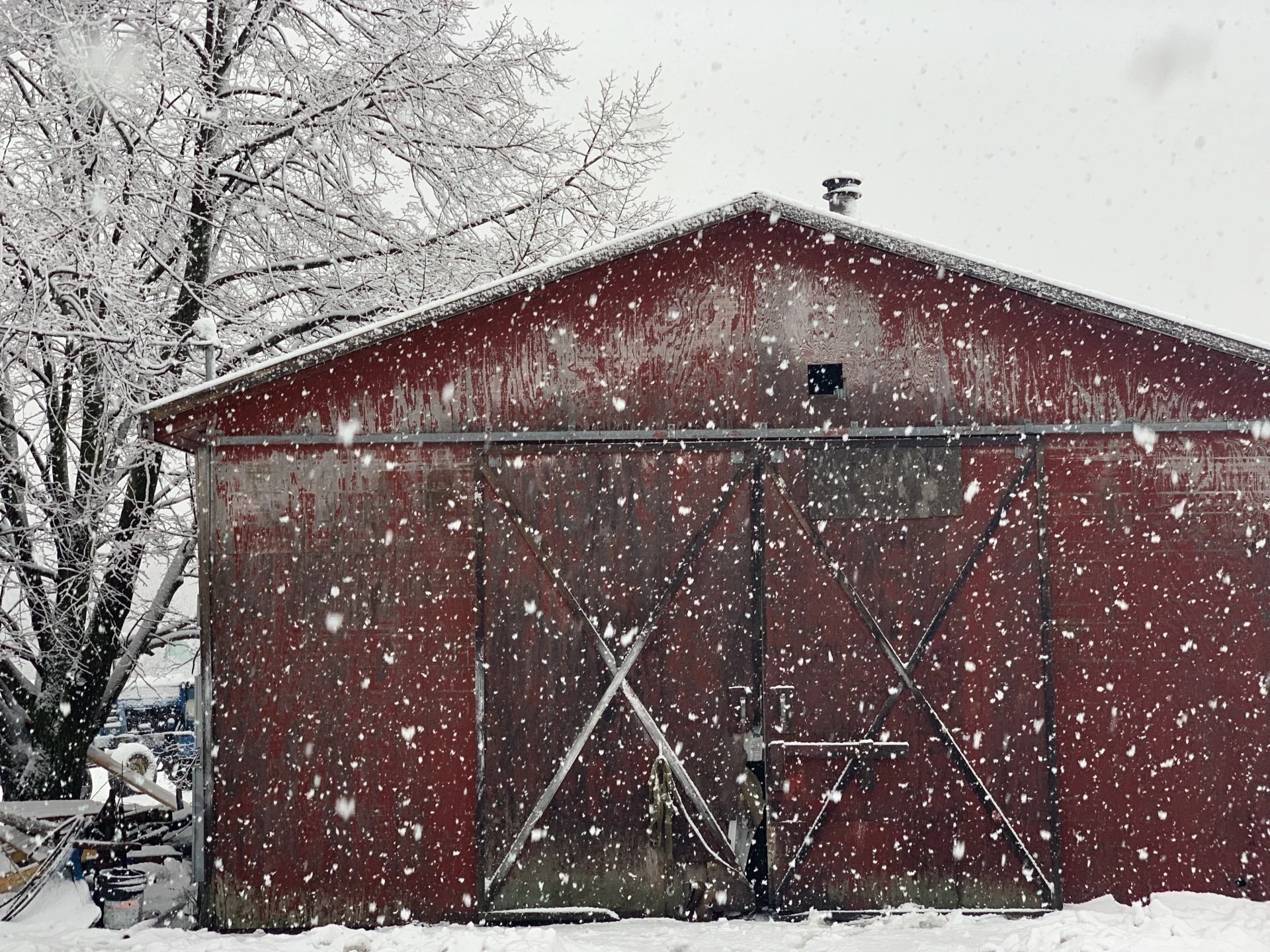 Red barn during a snowfall